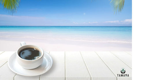 blue sky meeting the blue ocean white sandy beach with a coffee of coffee on a white table