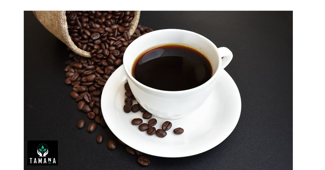 split dark brown coffee beans from a bag with a cup of coffee in white cup and saucer on a black table